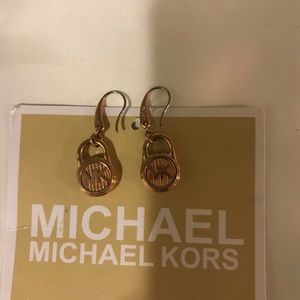 MK rose gold earrings.